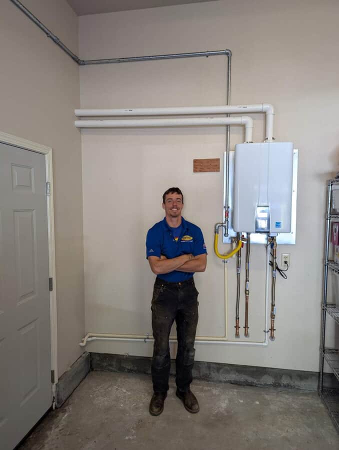 employee next to HVAC unit