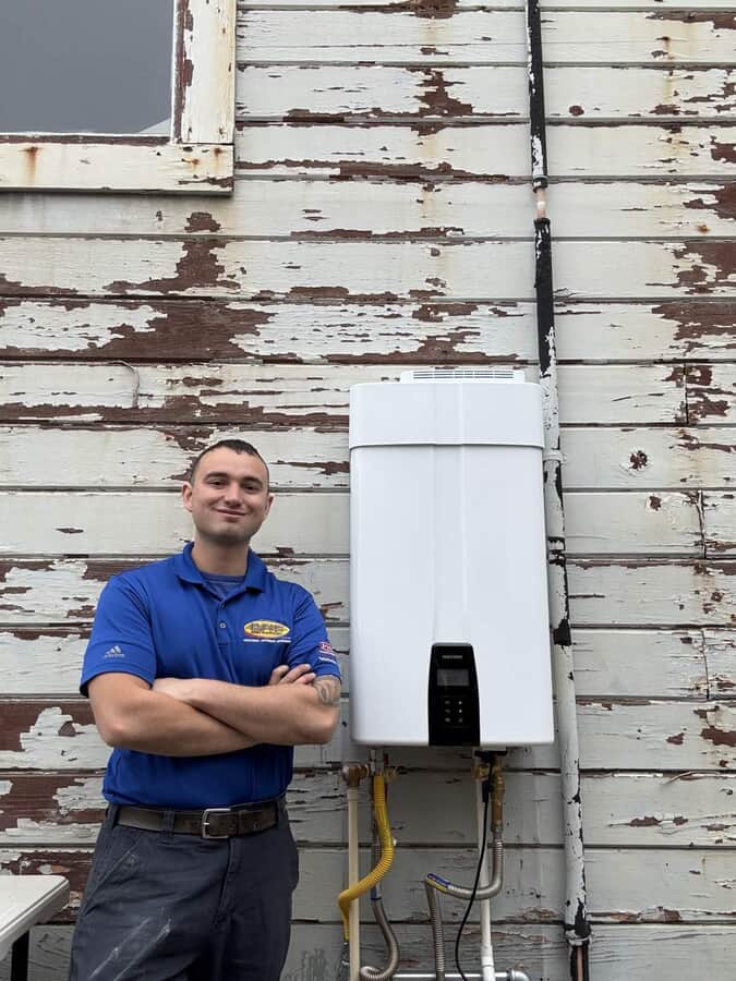 employee next to HVAC unit